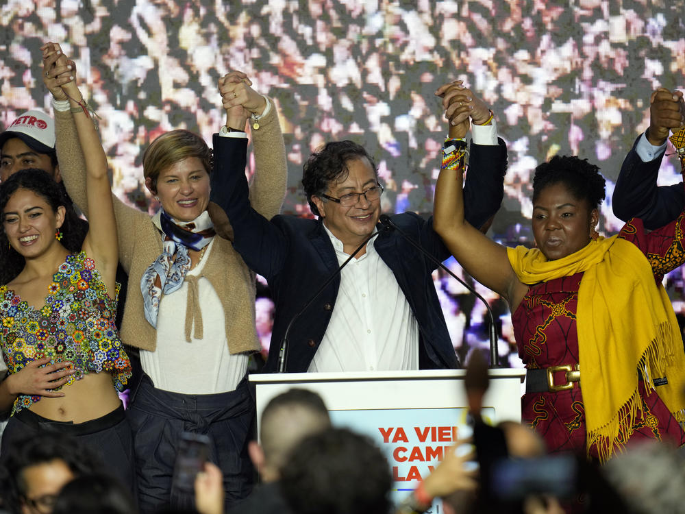 Presidential candidate Gustavo Petro, center, and his running mate Francia Marquez, at his right stand before supporters on election night in Bogota, Colombia, Sunday.