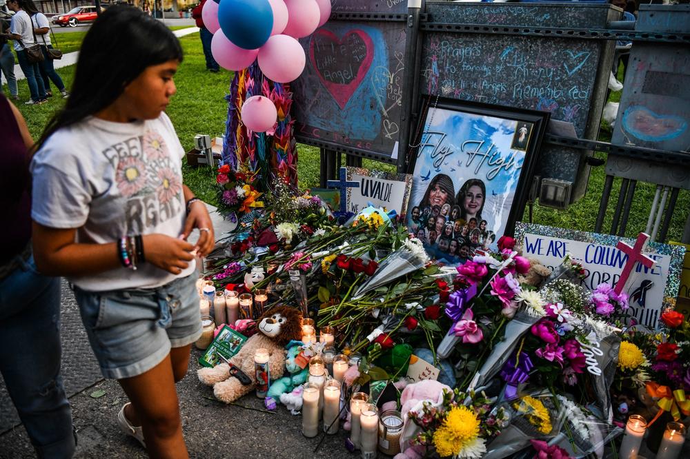 A girl visits a makeshift memorial for the shooting victims outside the Uvalde County Courthouse in Texas on May 28, 2022.