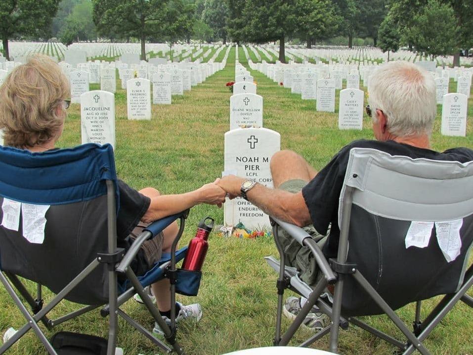 Vikki and Mark Pier visit the grave of their son, Noah, who was buried at Arlington National Cemetery in July 2011. They used to visit every few months, but they have been unable to make it in recent years.