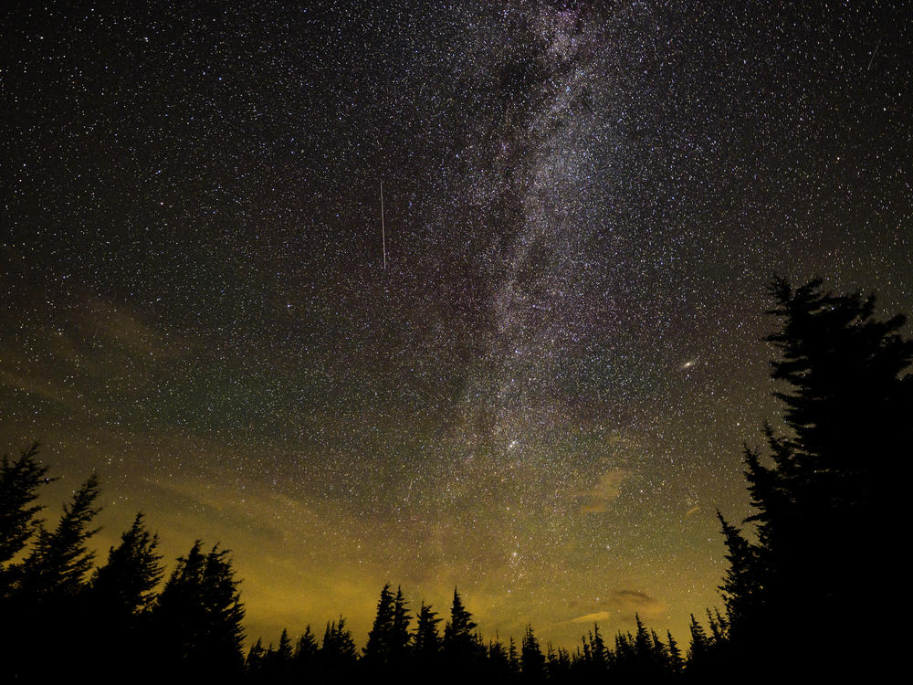 In this 30 second exposure, a meteor streaks across the sky during the annual Perseid meteor shower on Aug. 11, 2021 in Spruce Knob, W.Va.