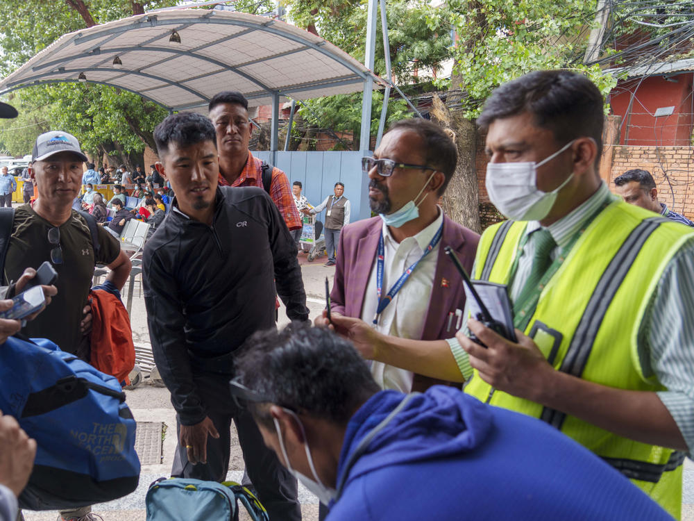 A team of climbers prepare to leave for rescue operations from the Tribhuvan International Airport in Kathmandu, Nepal, Sunday, May 29, 2022, following reports of a Tara Air flight that disappeared.