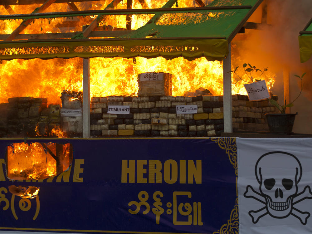 Smokes and flames billow from burning narcotic drugs during a destruction ceremony of seized narcotic drugs in outskirts of Yangon, Myanmar on June 26, 2018.
