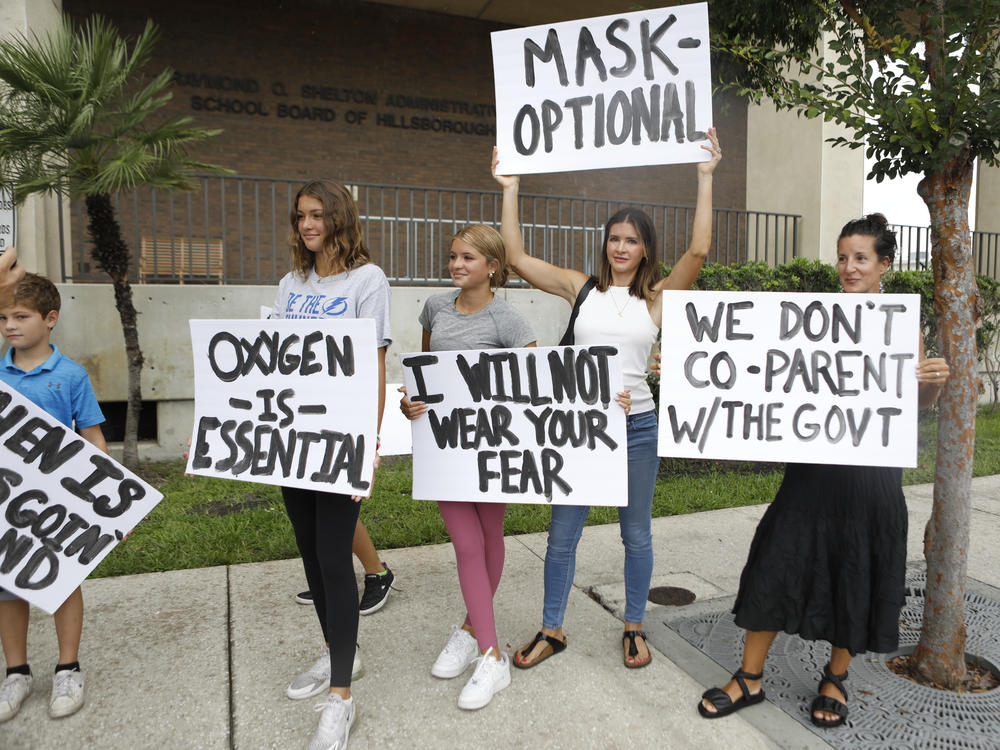 Anger over issues such as the mask mandate galvanized families — like these seen at the Hillsborough County School Board in Tampa, Fla., last year — into running for school board. Progressive groups are taking a leaf out of their playbook.