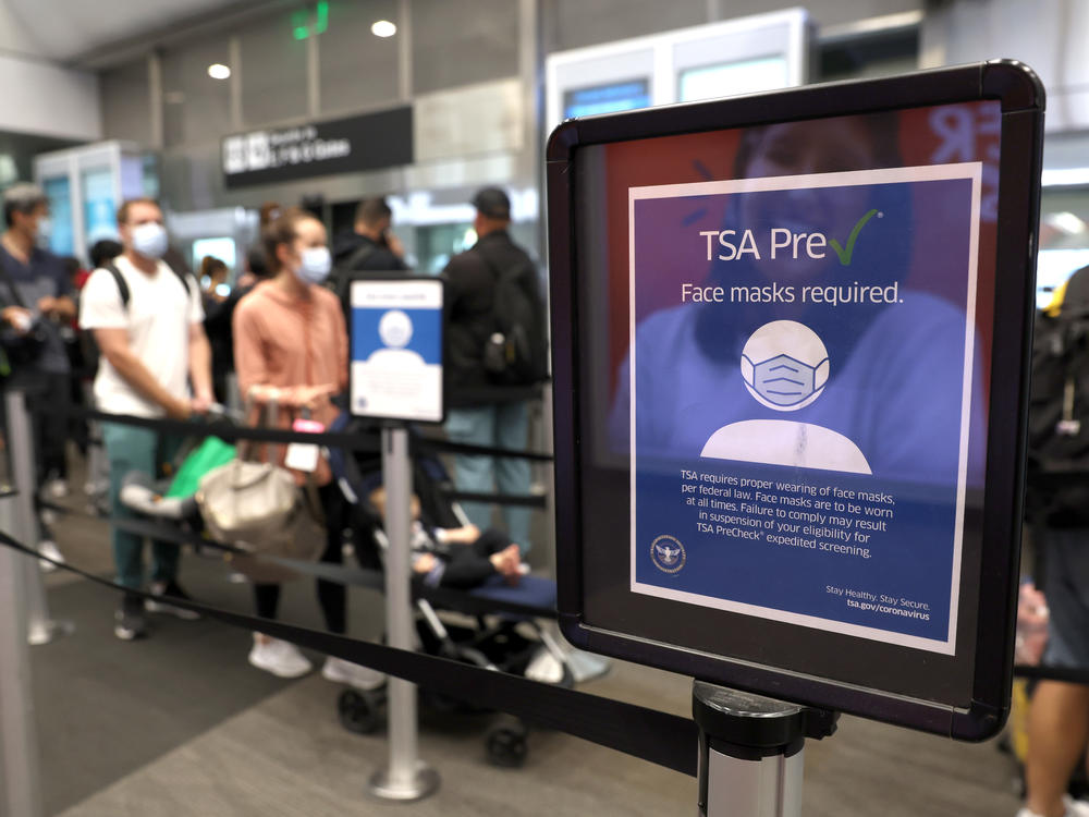 The U.S. Justice Department filed a brief in federal appeals court Tuesday to overturn a federal judge's decision that declared the government mask mandate on planes, trains and buses unlawful. Here, a sign stating that masks are required at San Francisco International Airport stands in a terminal after the federal mask mandate was overturned.