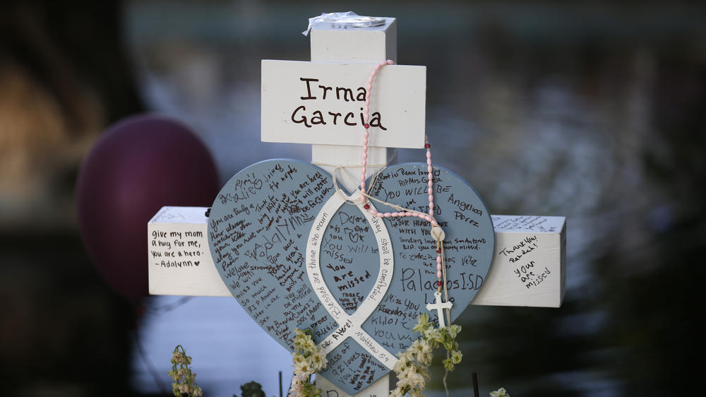 Irma Garcia's cross stands at a memorial site for the victims killed in this week's shooting at Robb Elementary School in Uvalde, Texas.