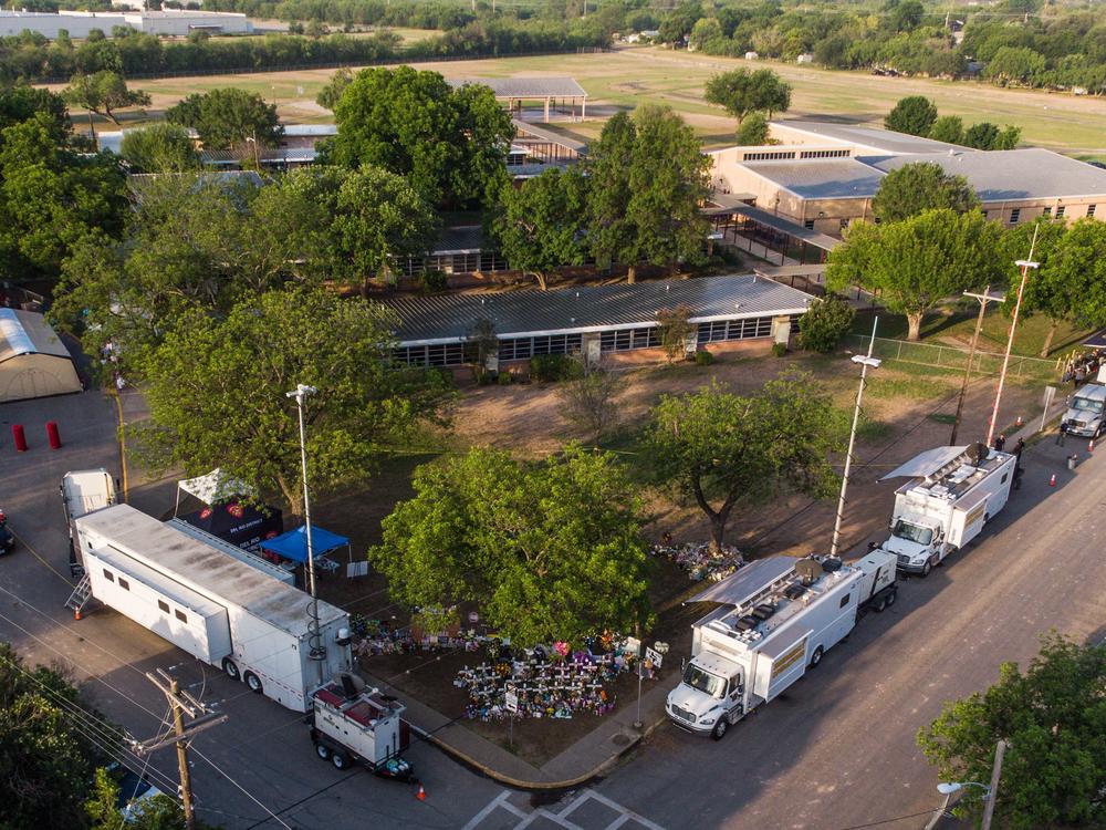 An aerial view of Robb Elementary School and the makeshift memorial for the shooting victims in Uvalde.