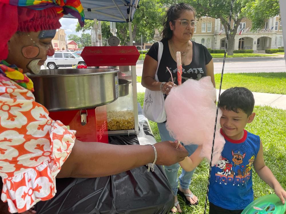 Dunbar hands cotton candy to Israel on Tuesday.