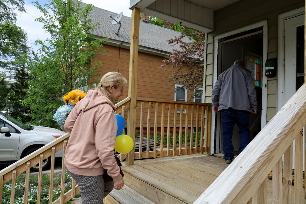 Halyna Terzi, left, and her husband Petro climb the stairs into their new apartment in Auburn, Maine, on May 16. The couple had been living in Poland after fleeing Ukraine in the early days of the war.