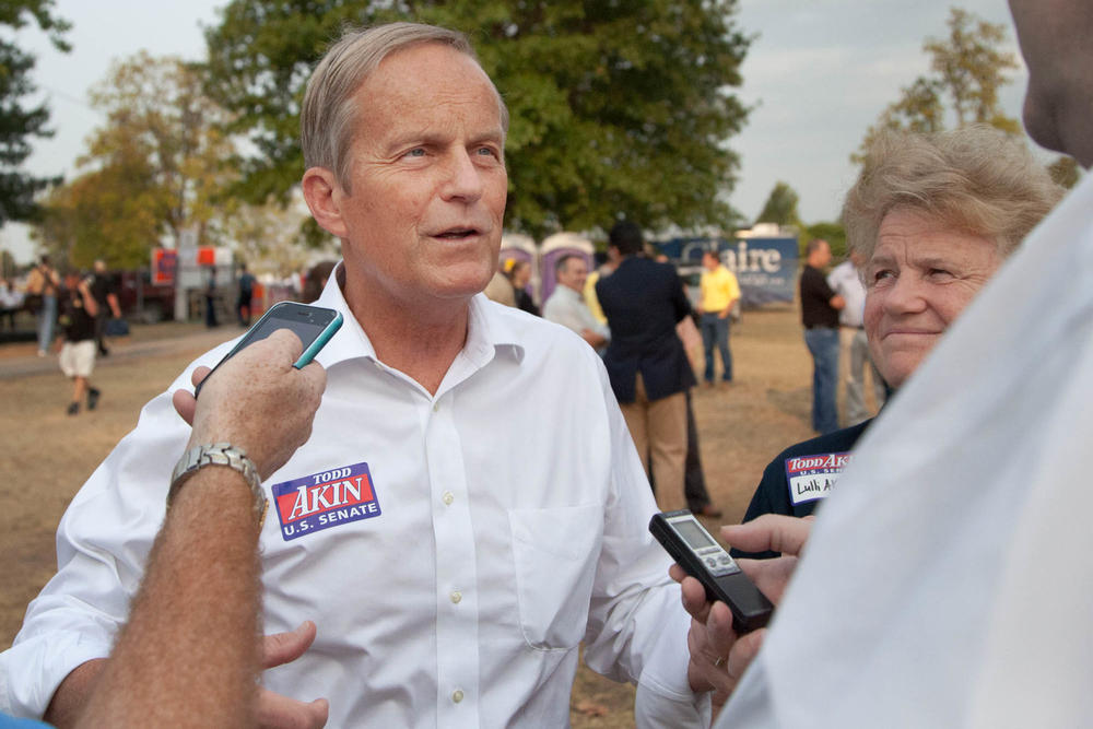 In this Aug. 16, 2012 photograph, former Rep. Todd Akin, R-Mo., and his wife Lulli, talk with reporters while attending the Governor's Ham Breakfast at the Missouri State Fair in Sedalia, Mo.