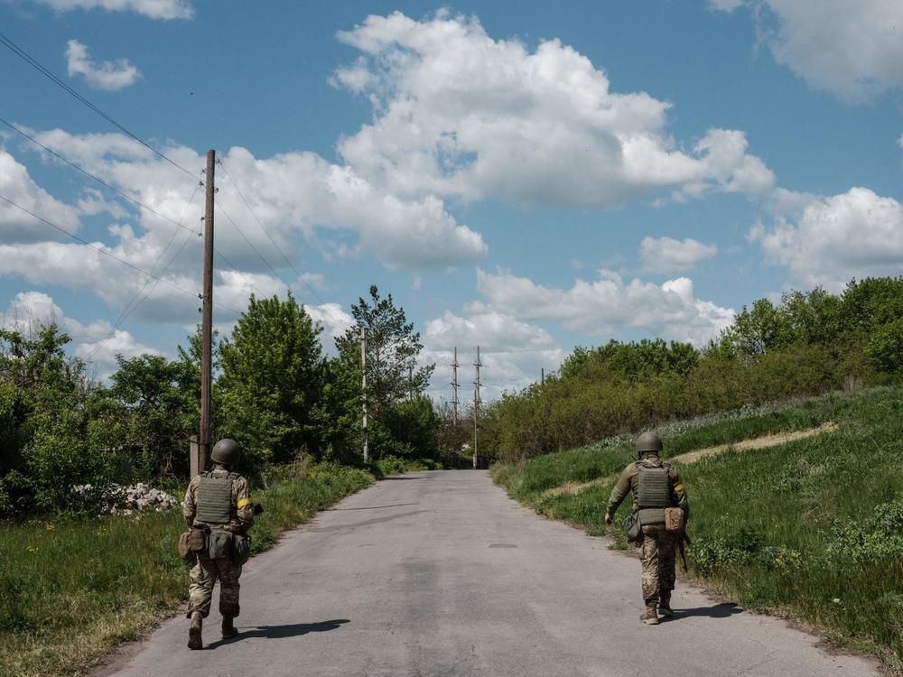 Ukrainian soldiers patrol on a road in Sydorove, eastern Ukraine, on May 17, 2022. The U.S. is sending Ukraine more advanced rocket systems and munitions in the fourth month of the war.