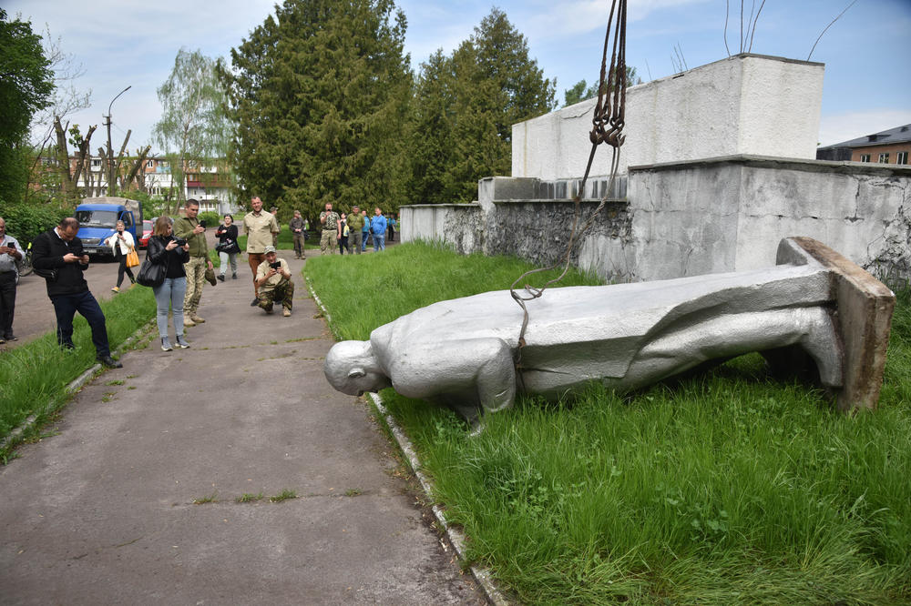A statue of a Soviet soldier lies facedown in Chervonohrad, in western Ukraine. The monument from the city's Eternal Flame memorial complex is among those that were dismantled following Russia's invasion of Ukraine.