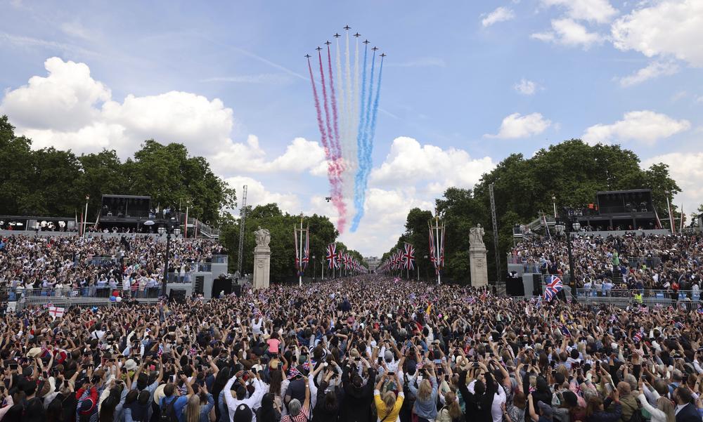 The red arrows fly over the crowd as they wait for the royal family to appear on a Buckingham Palace balcony.