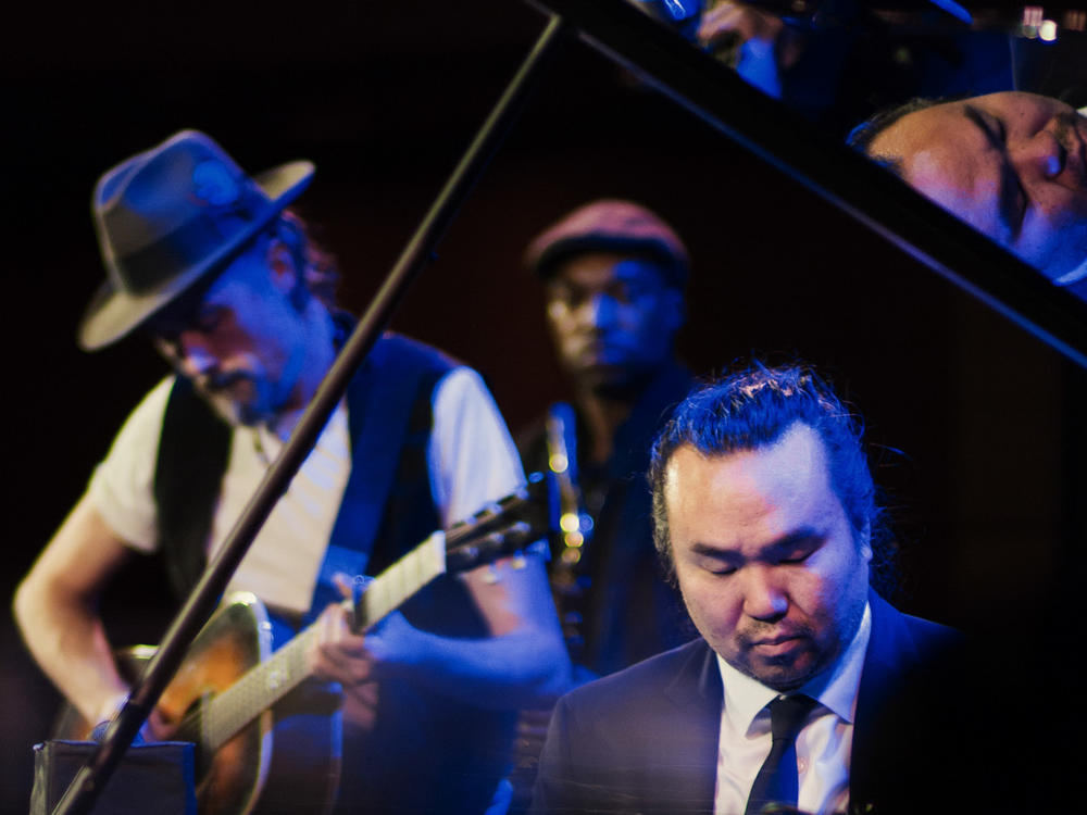 Vocalist and guitarist Richard Julian with pianist John Chin and saxophonist Stacy Dillard on stage at Dizzy's Club in 2018.