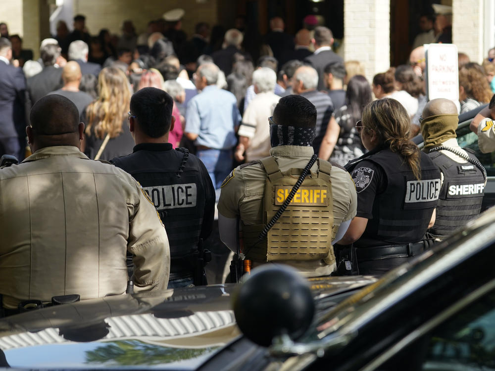 Guests arrive at the joint funeral service for Irma Garcia and her husband, Joe Garcia, at Sacred Heart Catholic Church in Uvalde, Texas, on Wednesday. Schoolteacher Irma Garcia died in the May 24 school shooting in Uvalde, and her husband died two days later of a heart attack.