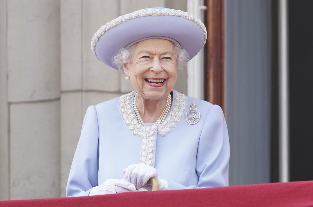 Queen Elizabeth II smiles as she watches from the balcony of Buckingham Palace after the Trooping the Color ceremony.