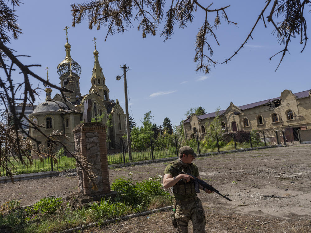 A Ukrainian serviceman patrols a village near the front line in the Donetsk oblast region, eastern Ukraine, Thursday.