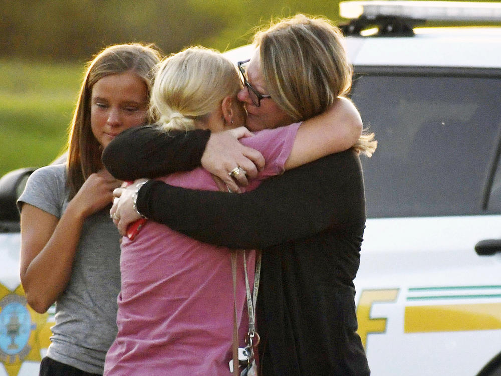 People console each other after a shooting at Cornerstone Church on Thursday, June 2, 2022 in Ames, Iowa. Two people and a shooter died Thursday night in a shooting outside a church in Ames, authorities said.