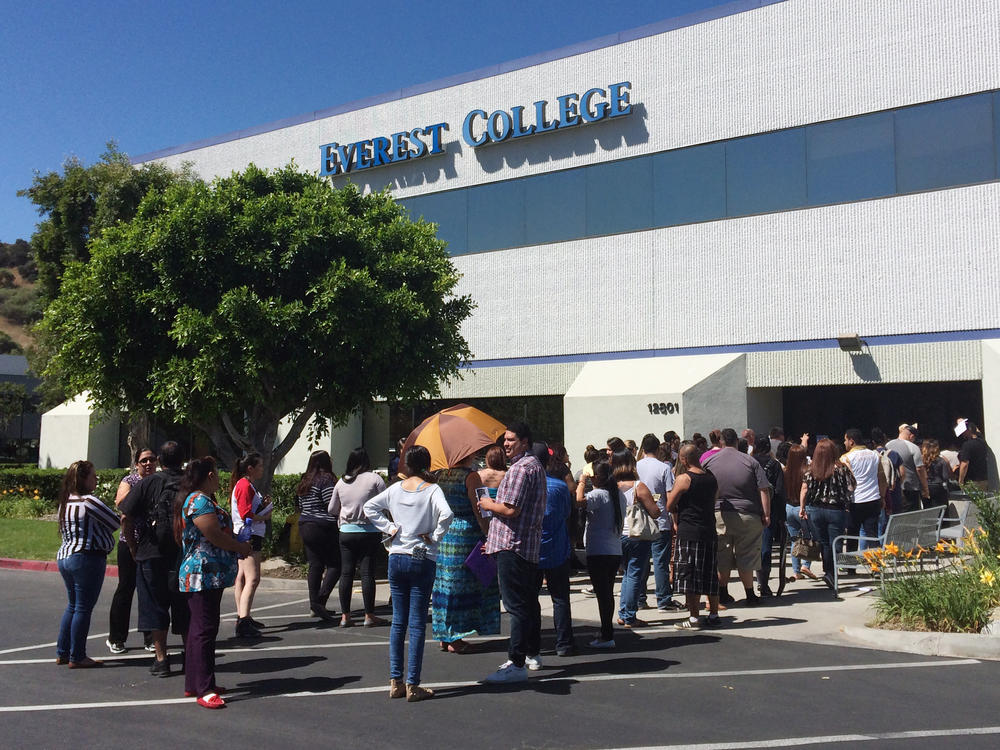 Students wait outside Everest College in Industry, Calif., in April, 2015, hoping to get their transcriptions and information on loan forgiveness and transferring credits to other schools.