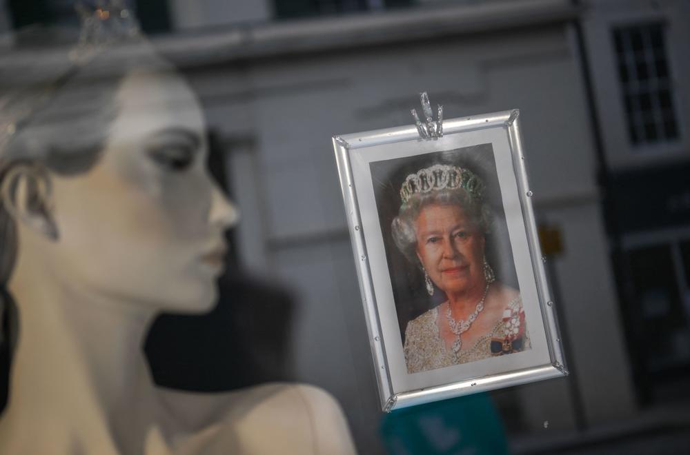 A portrait of Queen Elizabeth II hangs in a shop window in Colchester, England.