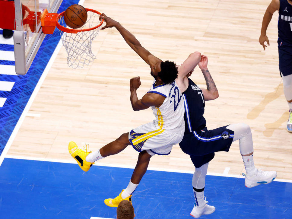 Andrew Wiggins of the Golden State Warriors dunks the ball against Luka Doncic of the Dallas Mavericks during the Western Conference Finals.