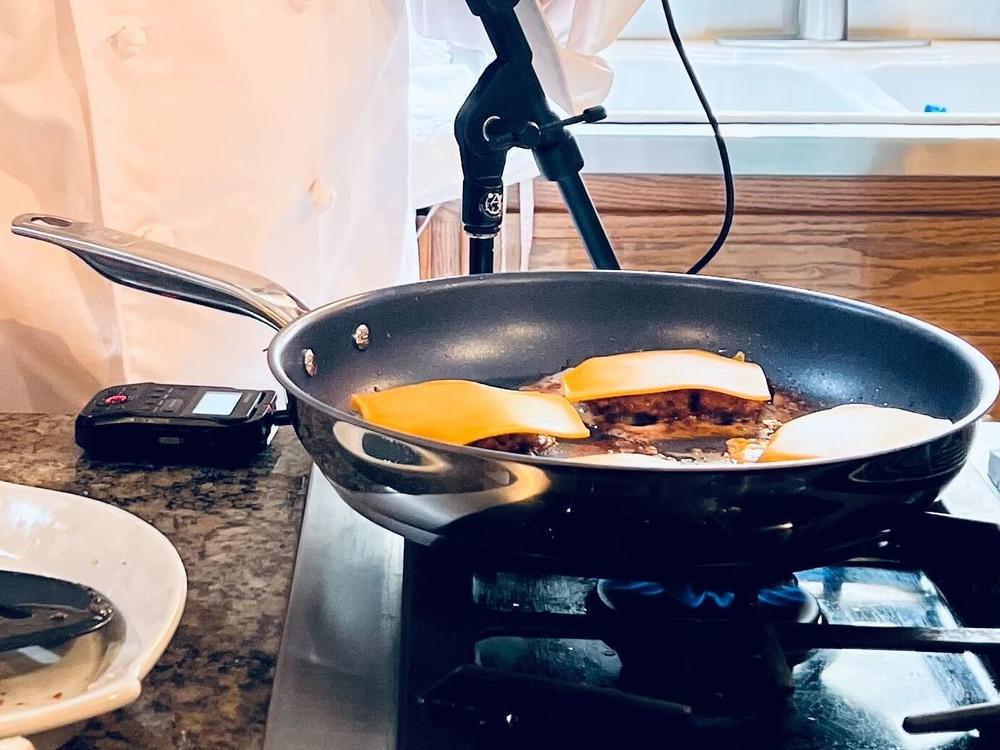 The patties cook with cheese on top.