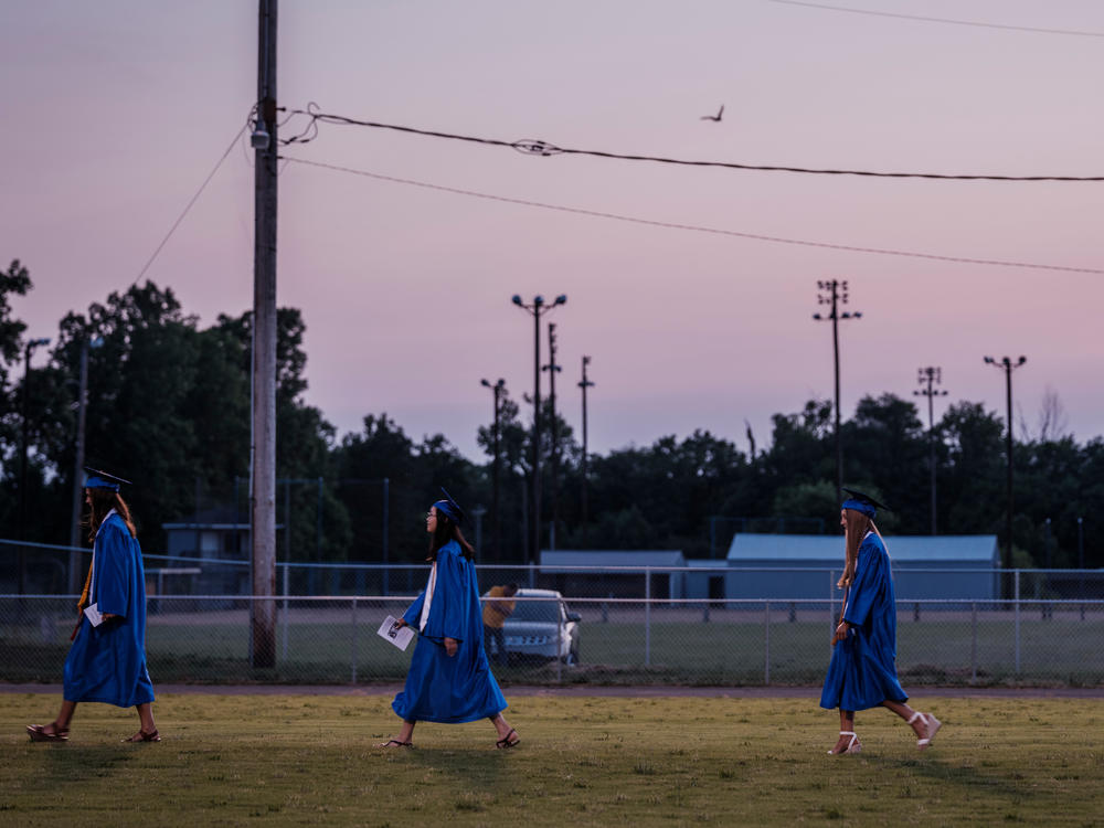 Zoe, second from left, walks onto the field with her fellow graduates. Zoey was one of eight Valedictorians and told her classmates, 