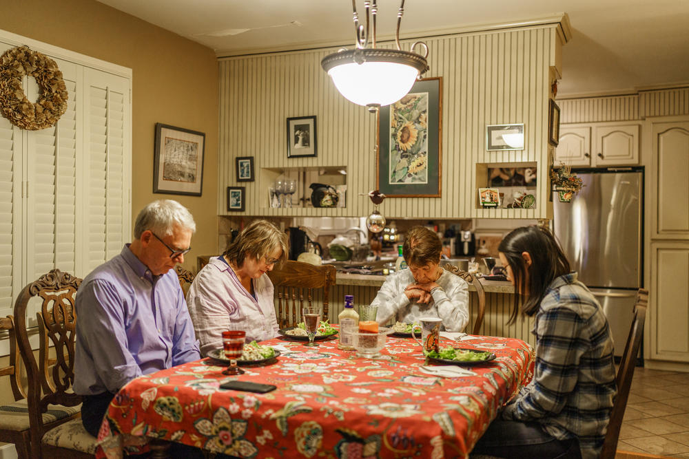 The Turners pray at the dinner table before eating at Zoe's grandmother's house.