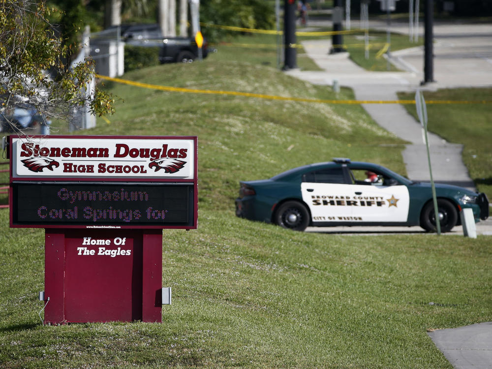 Law enforcement officers block the entrance to Marjory Stoneman Douglas High School in Parkland, Florida, the day after the deadly mass shooting there in 2018.