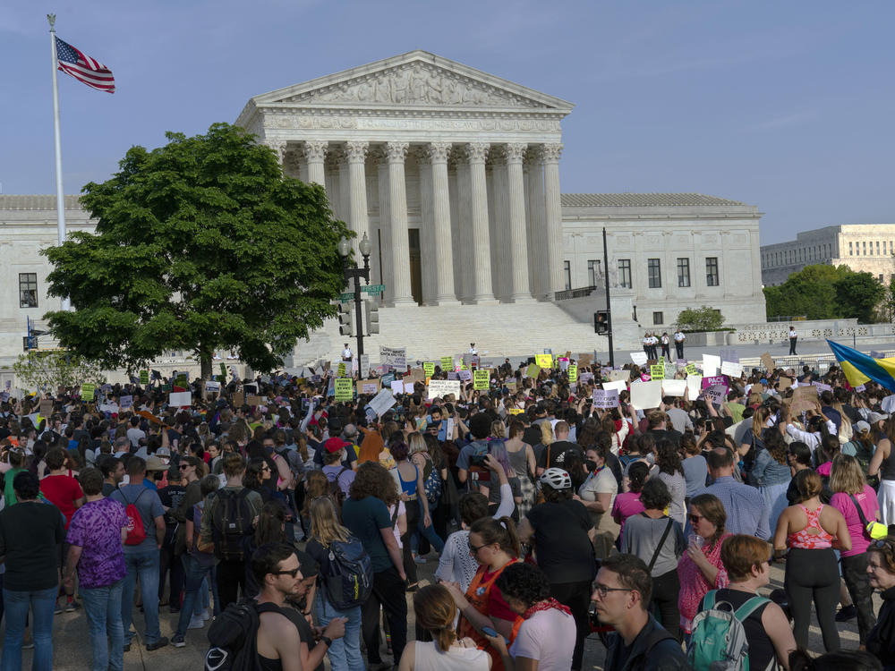 Abortion rights activists protest outside of the U.S. Supreme Court in Washington on May 3, a day after the leak of a draft opinion suggesting a possible reversal of <em>Roe v. Wade. </em>