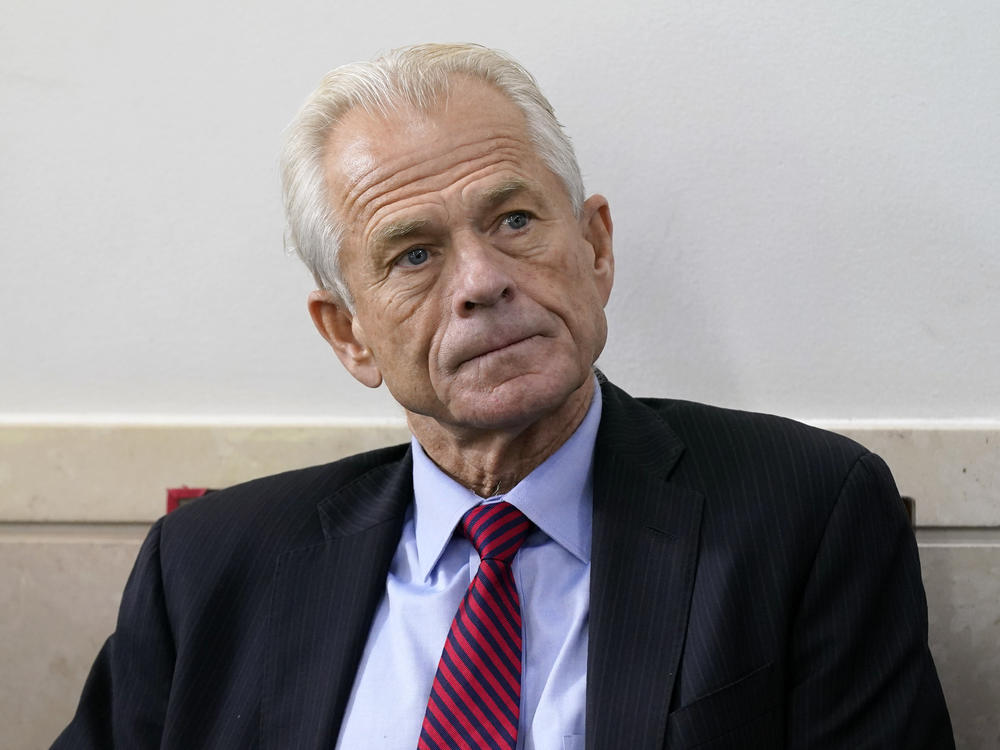 Former White House trade adviser Peter Navarro listens as former President Donald Trump speaks during a news conference at the White House, on Aug. 14, 2020.