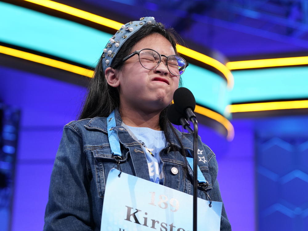 Kirsten Tiffany Santos, 11, from Richmond, Texas, reacts during the finals of the Scripps National Spelling Bee, Thursday, June 2, 2022, in Oxon Hill, Md.