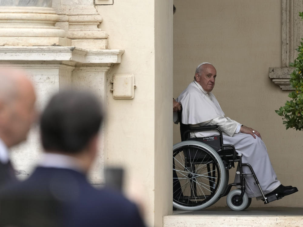 Pope Francis arrives on a wheelchair for an audience with children in the San Damaso courtyard at the Vatican, June 4, 2022.