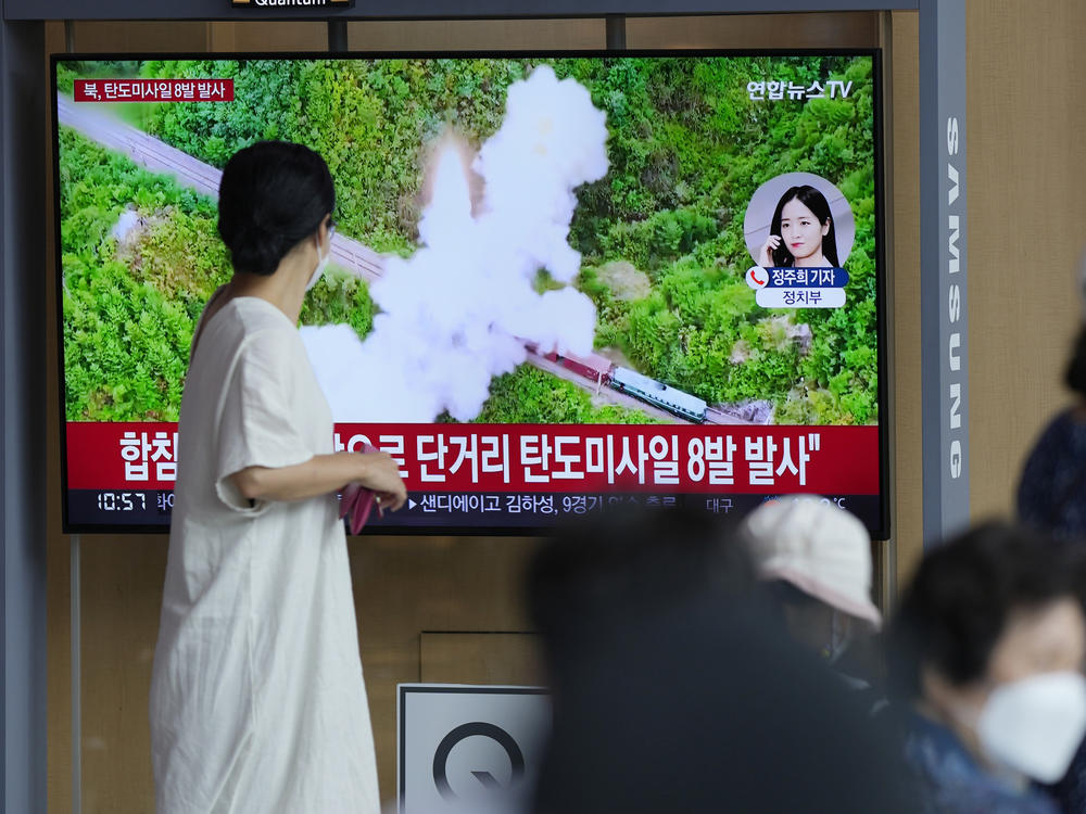 People watch a TV screen showing a news program reporting about North Korea's missile launch with file footage, at a train station in Seoul, South Korea, on June 5, 2022. North Korea test-fired a salvo of multiple short-range ballistic missiles toward the sea on Sunday, South Korea's military said.