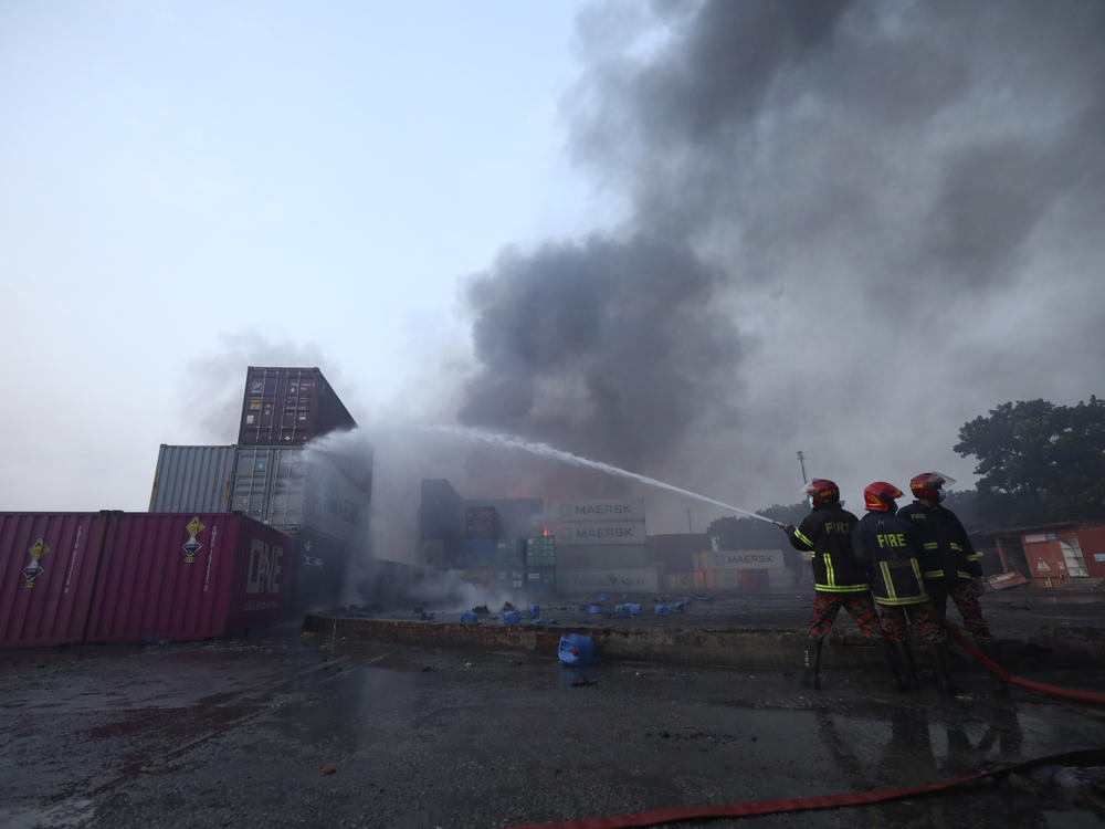 Firefighters work to contain a fire that broke out at the BM Inland Container Depot, a Dutch-Bangladesh joint venture, in Chittagong, Bangladesh, early Sunday.