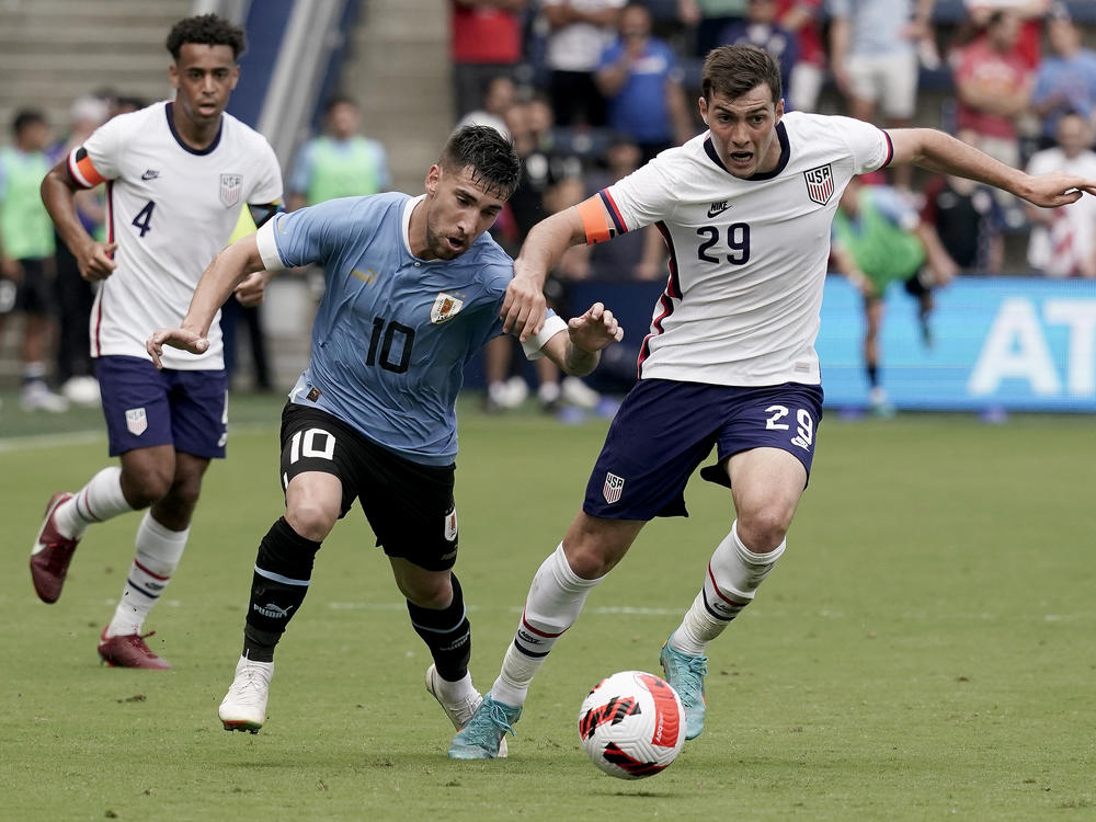 Uruguay midfielder Fernando Gorriaran and U.S. defender Joe Scally chase the ball during the first half of an international friendly soccer match on Sunday in Kansas City, Kan.