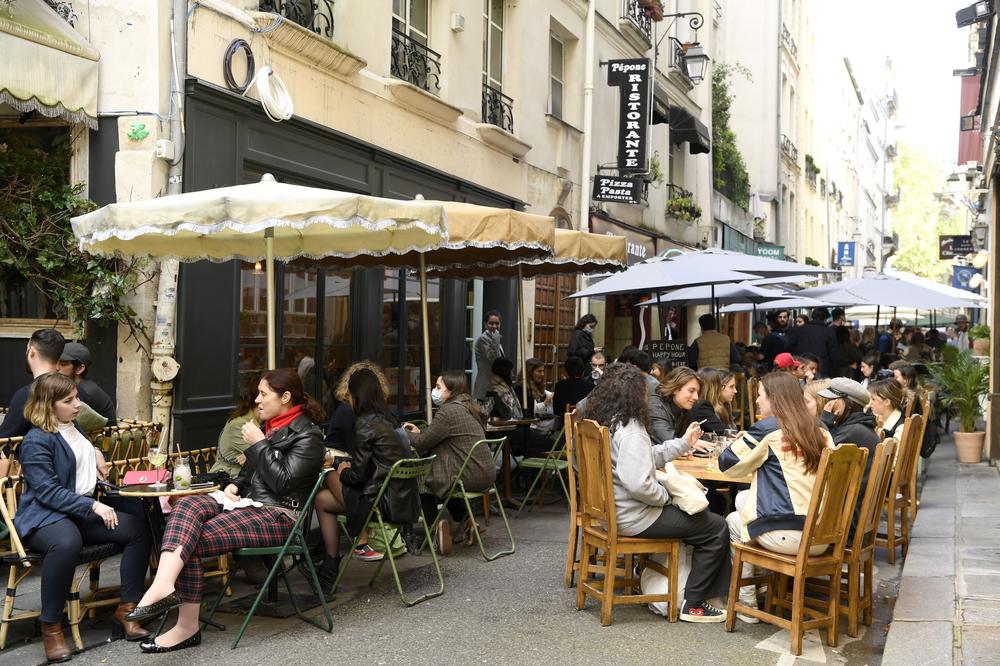 Diners sit outdoors on terraces in Paris on May 19, 2021, as cafes, restaurants and other businesses reopened as part of an easing of France's lockdown due to COVID-19.
