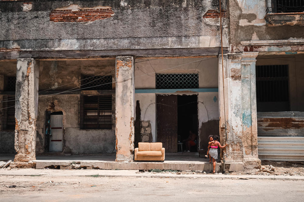 Children play outside a dilapidated residential building in Havana, Cuba, on July 13, 2021. The coronavirus pandemic helped devastate Cuba's economy, as tourism dried up.