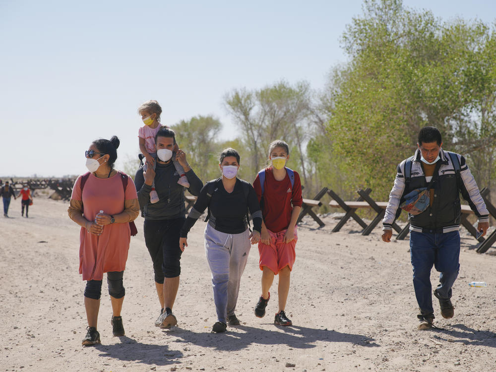 Asylum-seeking migrants from Colombia, Cuba and Venezuela arrive on U.S. soil, after crossing the Colorado River, from Mexico on Feb. 21, in Yuma, Arizona.