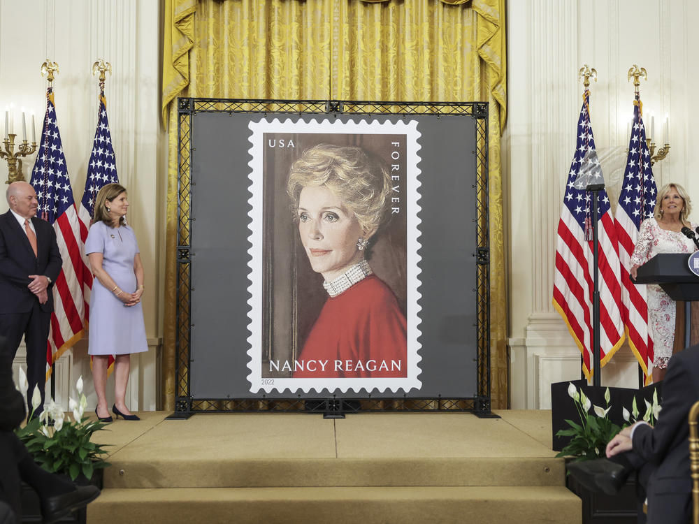 First lady Jill Biden (right) speaks onstage with Postmaster General Louis DeJoy and Anne Peterson, former first lady Nancy Reagan's niece, at the unveiling of the Nancy Reagan stamp at the White House on Monday.