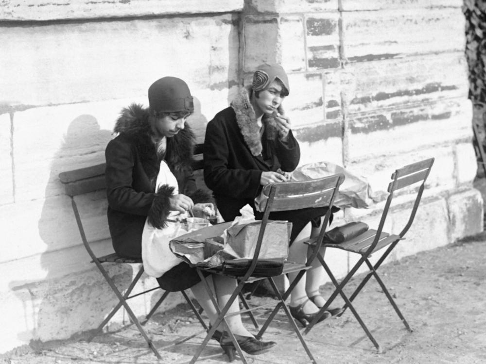Young women eat lunch in the Tuileries Garden in Paris in January 1929.