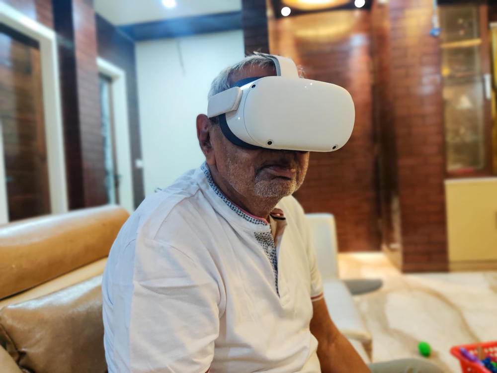 Ishar Das Arora, 83, watches a 3-D video of his birthplace in Pakistan, through a virtual reality device.