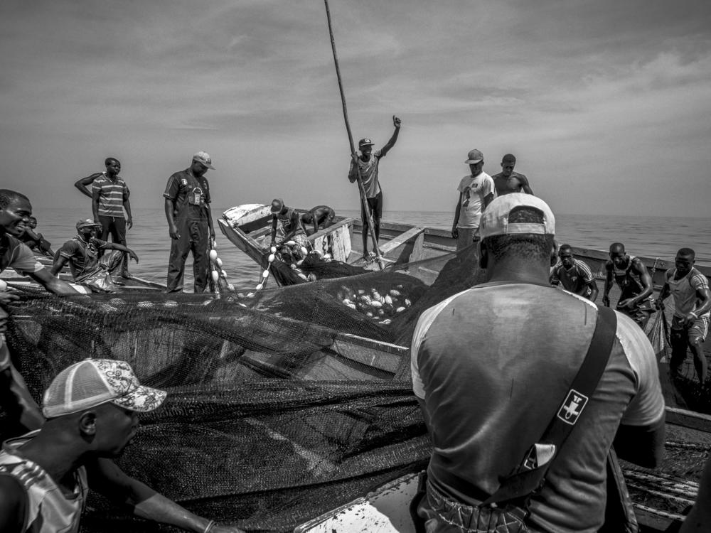 Fishermen haul in a fishing net in the eastern central Atlantic off Senegal. Belgian photographer Pierre Vanneste documents commercial fishing in his black-and-white photos.