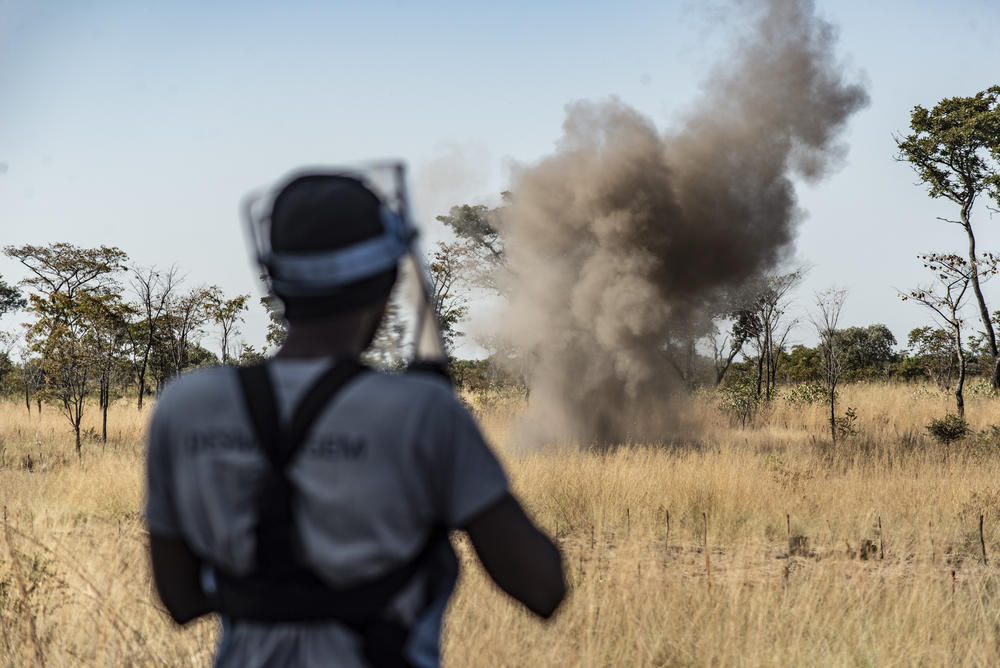 A deminer detonates a South African-made R2M2 landmine. She's part of the HALO Trust demining effort, which has destroyed thousands of landmines in Angola but many more remain underground.