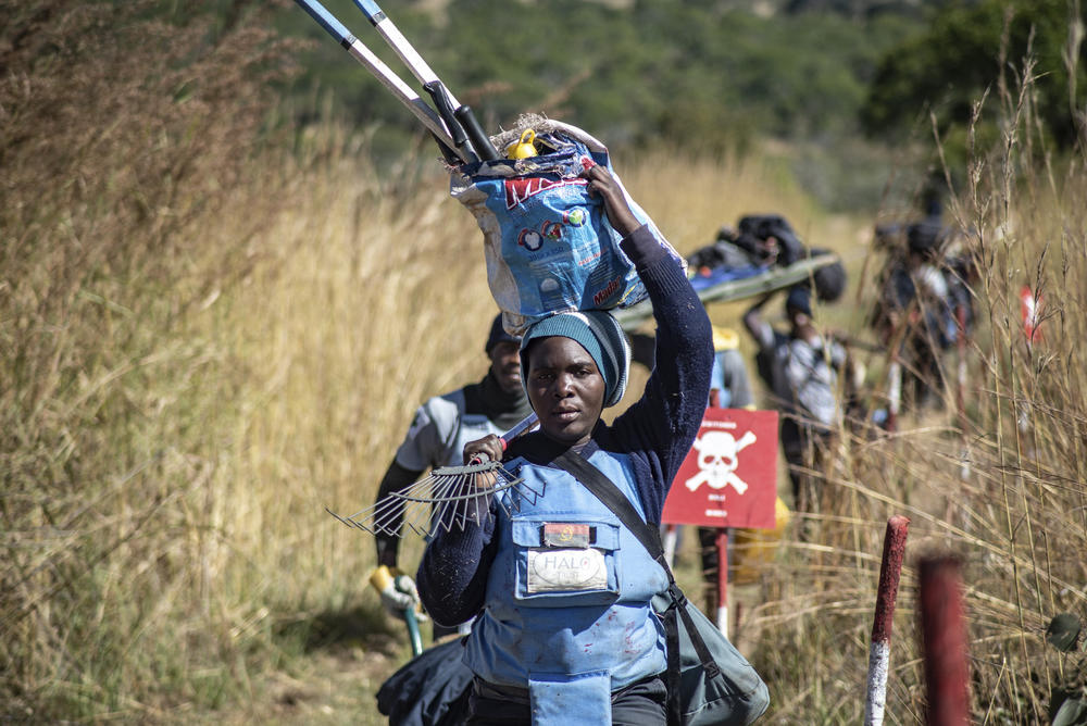 Deminers return from a minefield on the banks of the Lomba river in southern Angola. Nearly half of the deminers working for the  HALO Trust in Angola are women.