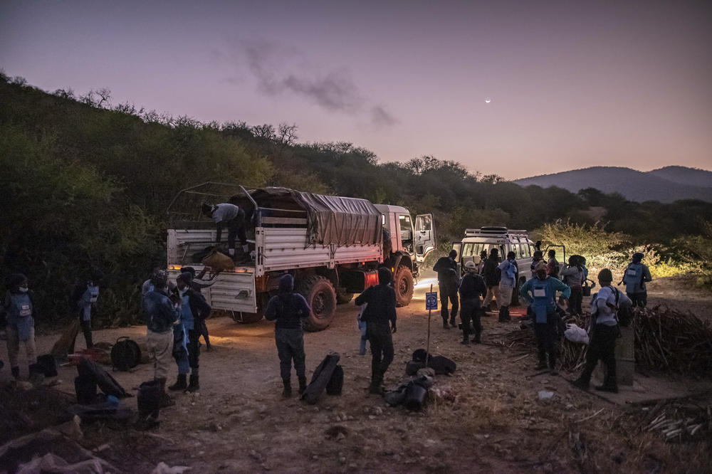 Demining teams disembark from their vehicles at the start of the day on the edge of a minefield in Benguela province, Angola.