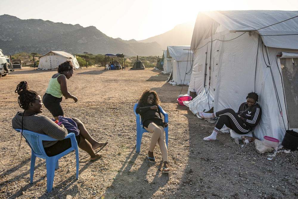 Deminers chat after work at their camp in the bush in Benguela province, Angola. The women have been working to clear a minefield laid in the 1980s during the country's civil war.