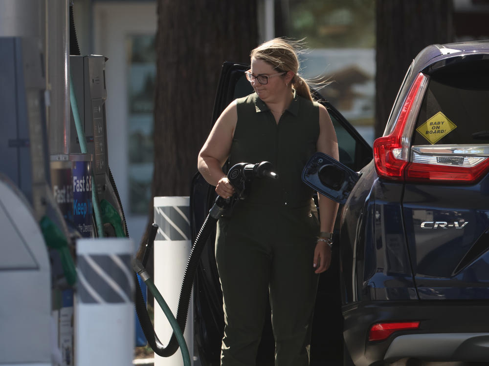 A customer prepares to pump gas into her car at a gas station in San Rafael, Calif., on May 20. Surging gas prices have been a major pain point for many household budgets.