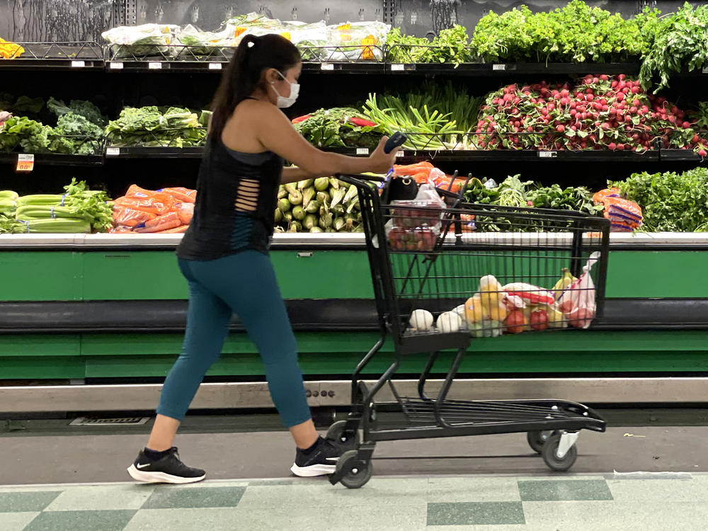 A customer shops at a grocery store in San Rafael, Calif., on June 8. Inflation has surged to its highest rate in nearly 40 years, and Americans are having to adjust some of their spending patterns.