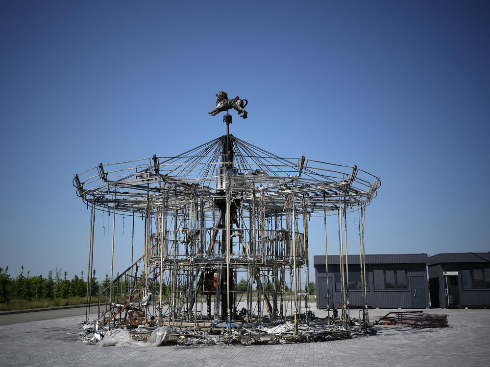 The remains of a carousel destroyed during the Russian invasion stand on the grounds of Dobropark, a children's theme park on the outskirts of Kyiv, on Friday. The park will reopen next week.