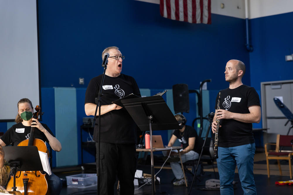 Vocalist Scott Graff and oboist Aaron Hill performing with a Street Symphony ensemble.